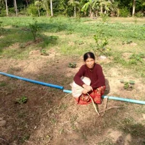 Poverty Reduction - Cambodian farmer sits in the field